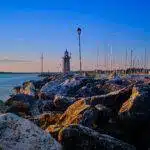 The light brick Italian lighthouse in the port of Desenzano del Garda, Lombardy, Italy.